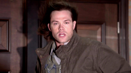 Sam's hair is blown back as he watches Dean.
